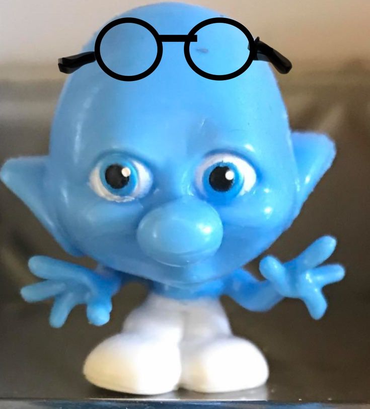 a close up of a blue toy with glasses on it's head and eyes