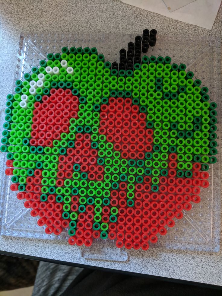 an apple made out of legos sitting on top of a table