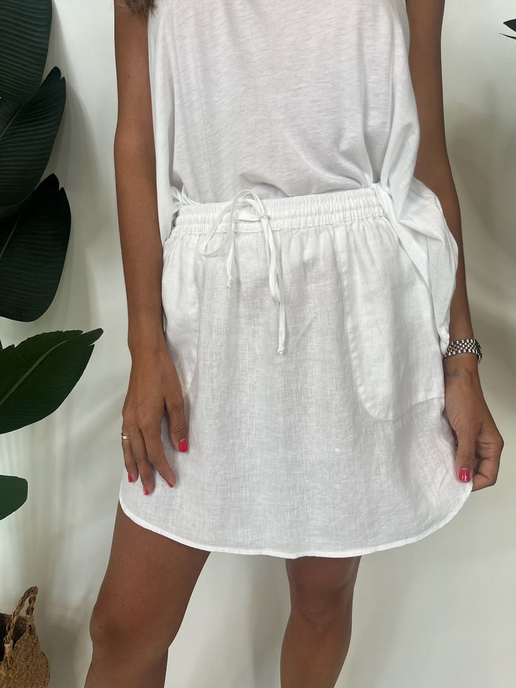 Get ready to breeze through your day in style with our Fresh Laundry Linen Skirt. Made from lightweight, breathable linen and featuring a drawstring elastic waist, this skirt is the perfect blend of comfort and fashion. Say goodbye to heavy and uncomfortable clothing, and hello to effortless style! Color: White, Navy 100% Linen Made In The USA Hand Wash Or Dry Clean Alyssa is 5'10" Wearing a Size Small Fresh Laundry, Apparel Boutique, Linen Skirt, Say Goodbye, White Skirts, Boutique Clothing, Effortless Style, Elastic Waist, Color White