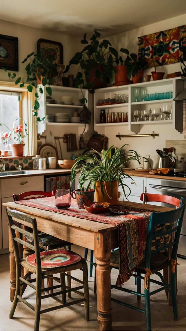 a wooden table topped with two potted plants next to a kitchen stove top oven