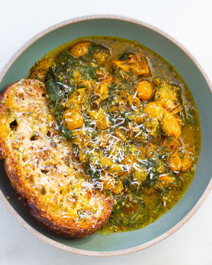 a bowl filled with soup and bread on top of a table