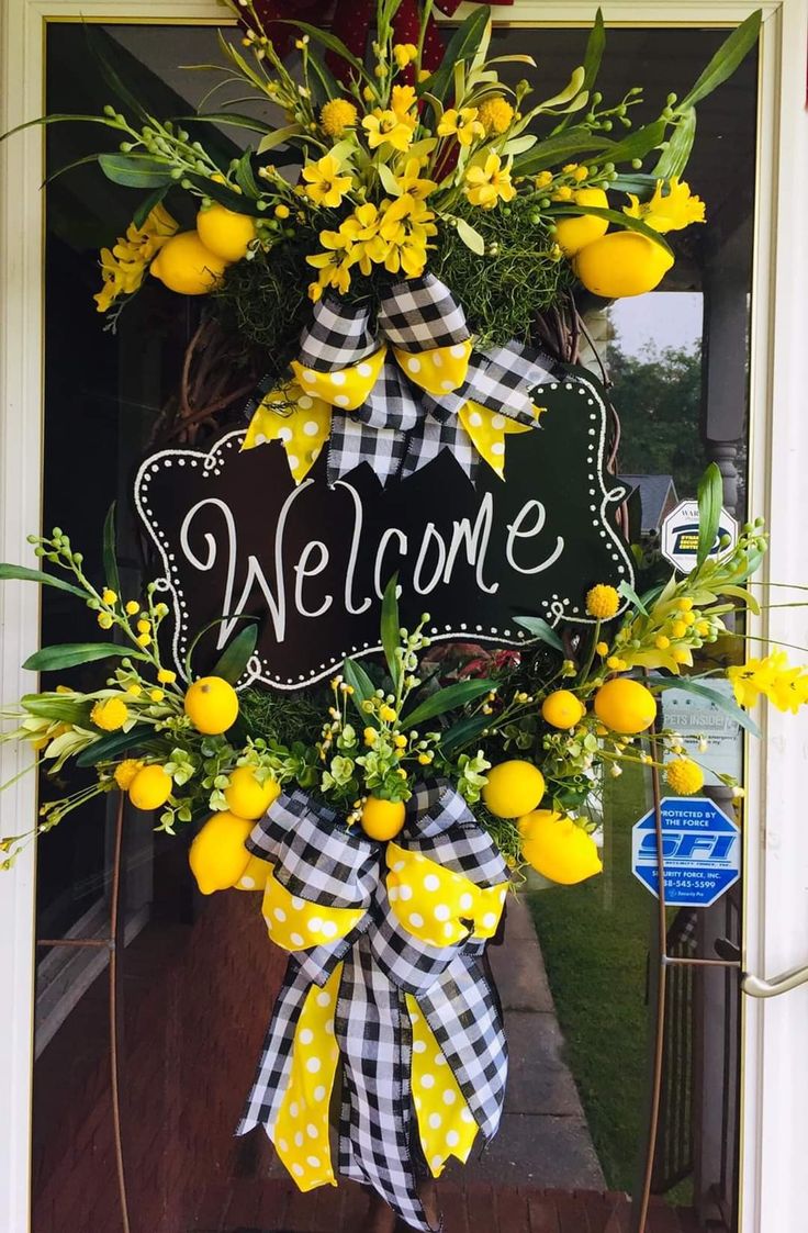 a welcome wreath with yellow flowers and gingham ribbon hanging on the front door