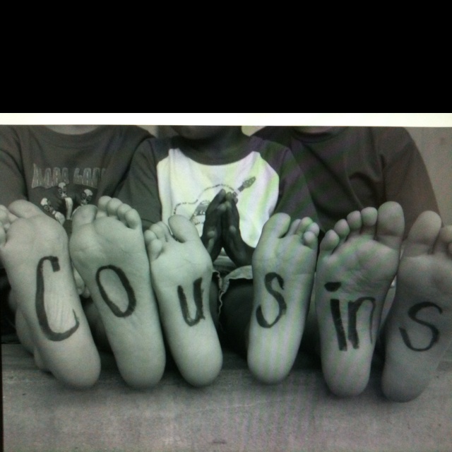 four feet with words written on them in front of a black and white photo,