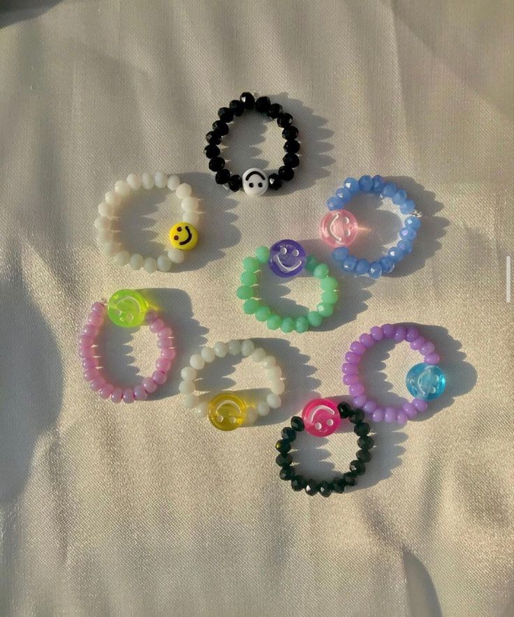 several different colored bracelets with smiley faces on them