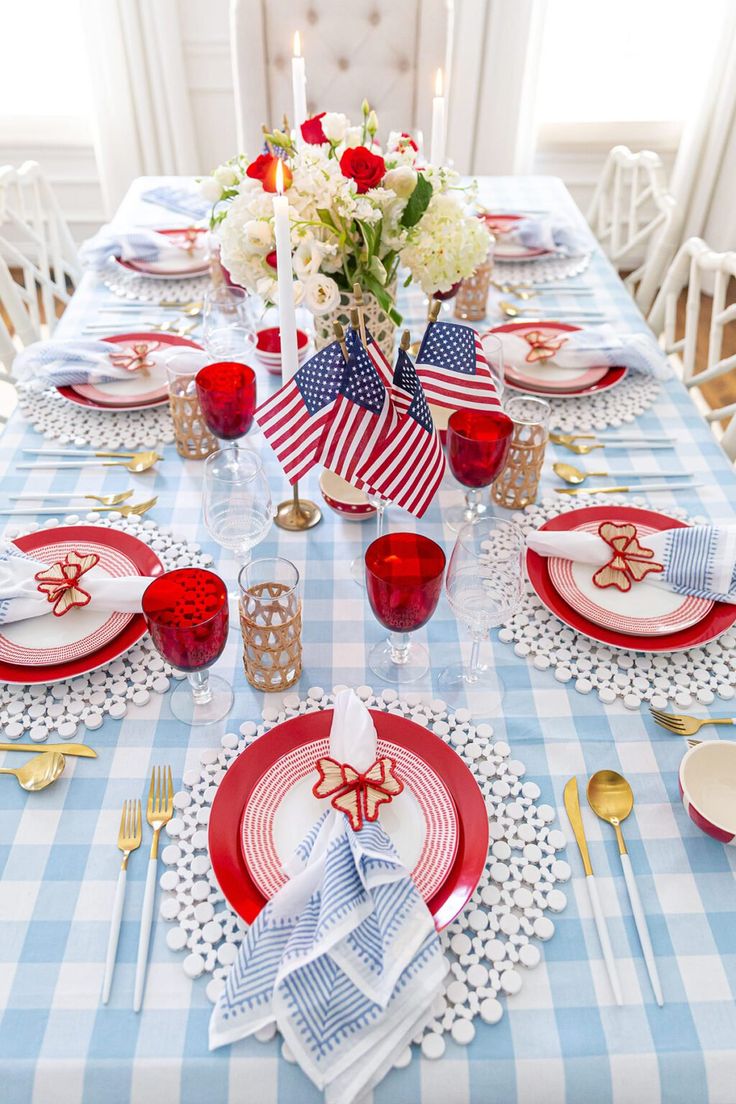 a table set with red, white and blue place settings for an american flag themed party