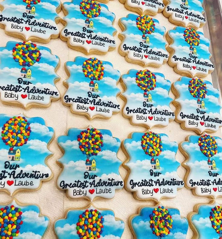 decorated cookies with balloons are on display for guests to enjoy in the sky at an event