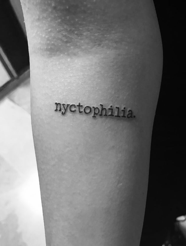 a person with a tattoo on their leg that says, mytophiia in black and white