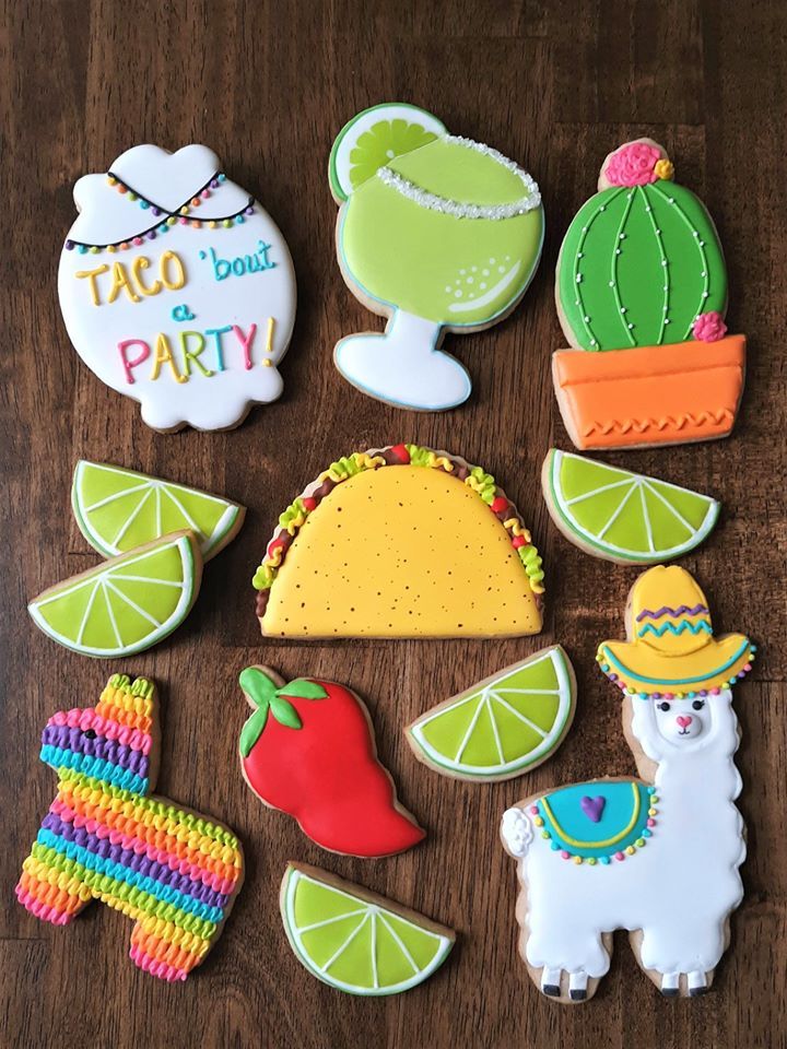 decorated cookies are arranged on a table with the words taco bout and party written on them