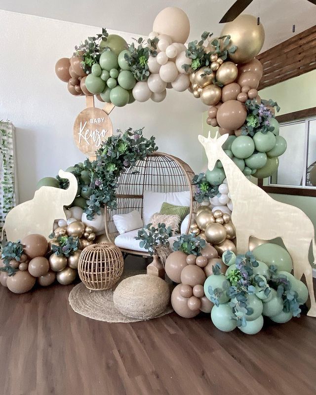 the balloon arch is decorated with animals, plants and other decorations in pastel colors