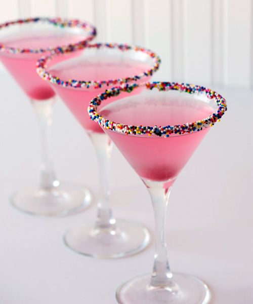 three glasses filled with pink liquid and sprinkles