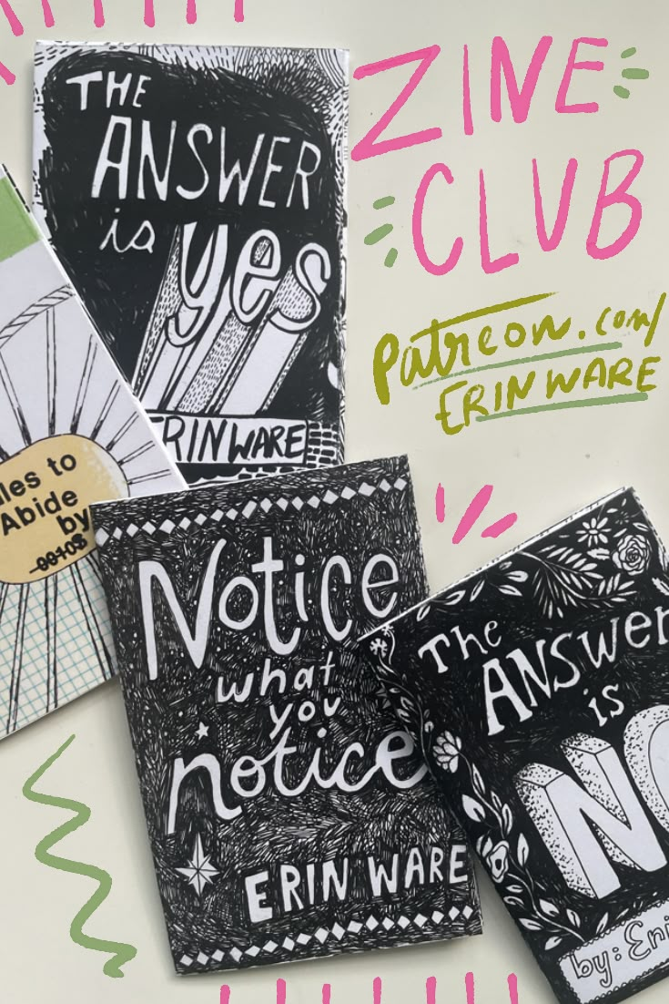 some black and white papers with writing on them, including one that says the answer is zine club