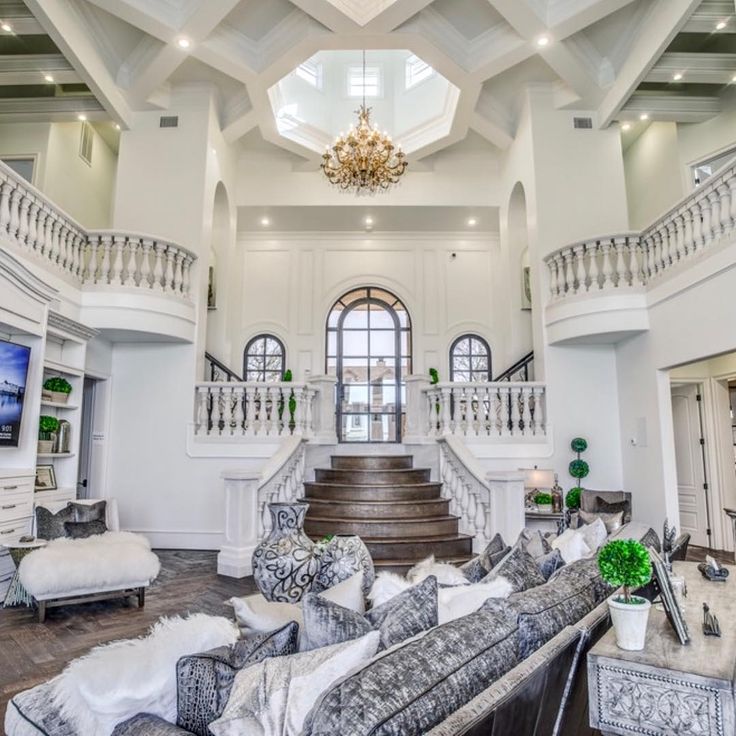 a large living room with high ceilings and white walls