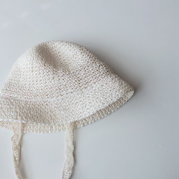 Keep the sun at bay with this straw bucket hat — a perfect pair with warm-weather looks! Adorable lace straps to keep this hat on your little ones head with a delicate touch. Best fit for 1-5 years, depending on head size. Cute Beige Sun Hat For The Beach, Spring Sun Hat With Crochet Trim And Curved Brim, Cute Beige Beach Sun Hat, Cute Adjustable Beige Sun Hat, Summer Crochet Hat In Cream, Cream Summer Crochet Hat, Cute Brimmed Straw Hat For Beach, Summer Adjustable Crochet Hat With Crochet Trim, Adjustable Crochet Hat With Crochet Trim For Summer