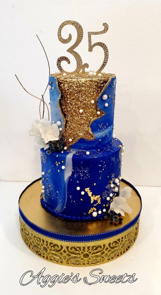 a blue and gold cake with the number twenty five on it