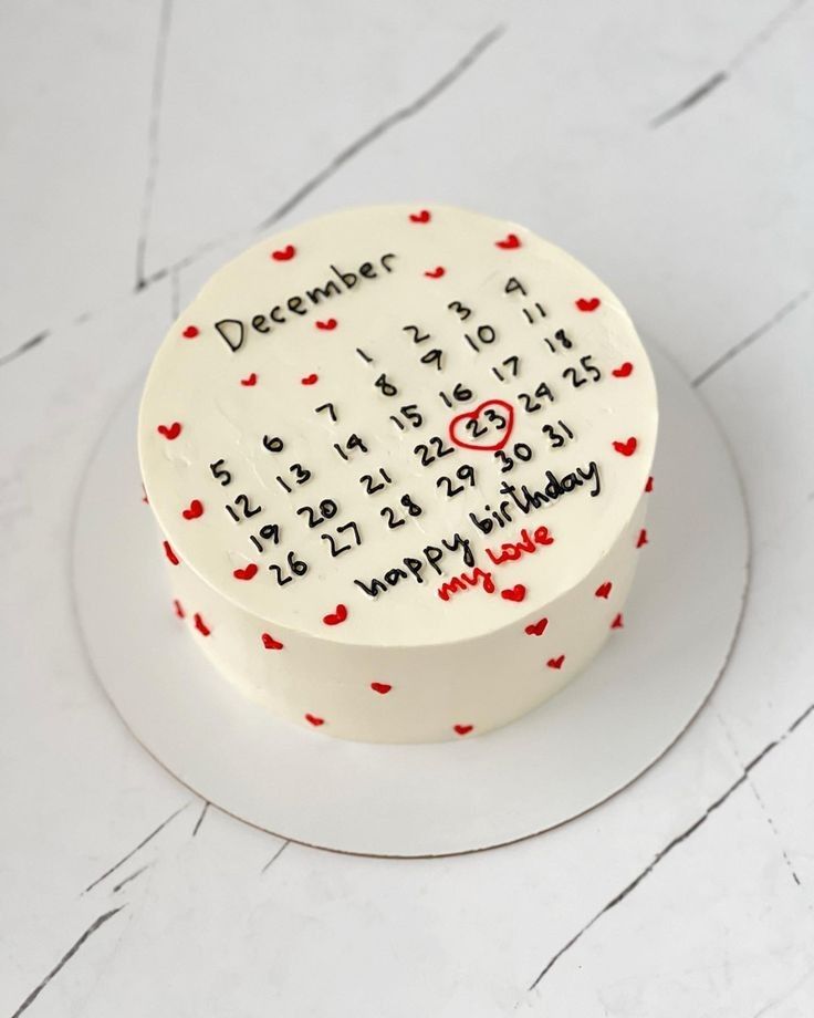 a white cake with red hearts on it