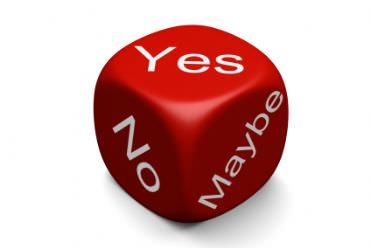 a red dice with the words yes and no on it