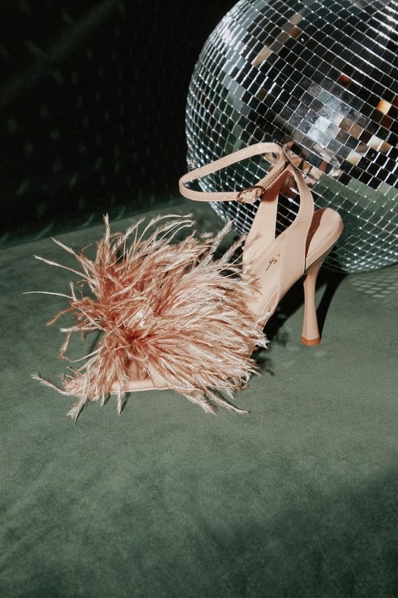 Nothing says it's party time like the Lulus Harlee Light Nude Patent Feather High Heel Sandals! Shiny patent faux leather shapes these luxe heels that have a pointed-toe footbed, toe strap, and matching strap at the ankle that secures with a shiny gold oval buckle. Fluffy matching feathers and a clear sphere accent the toe strap for a glam finishing touch! 4. 25" stiletto heel. Cushioned insole. Rubber sole has nonskid markings. Upper Material: PU. Sole Material: Rubber. Imported. Lulus | Harlee Bridal Shoes With Feathers, Summer High Heels With Feathers, Ostrich Feather Heels, Summer Feathered High Heels, Chic High Heels With Feathers, Champagne Heels, Feather Sandals, Feather Shoes, Forest Green Dresses