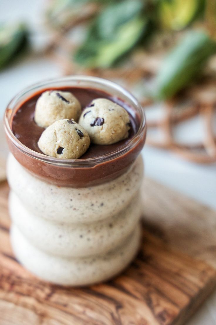 three cookies in a jar on top of a cutting board