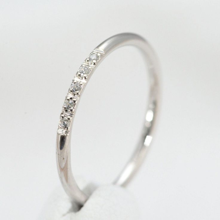 a white gold ring with five diamonds on it