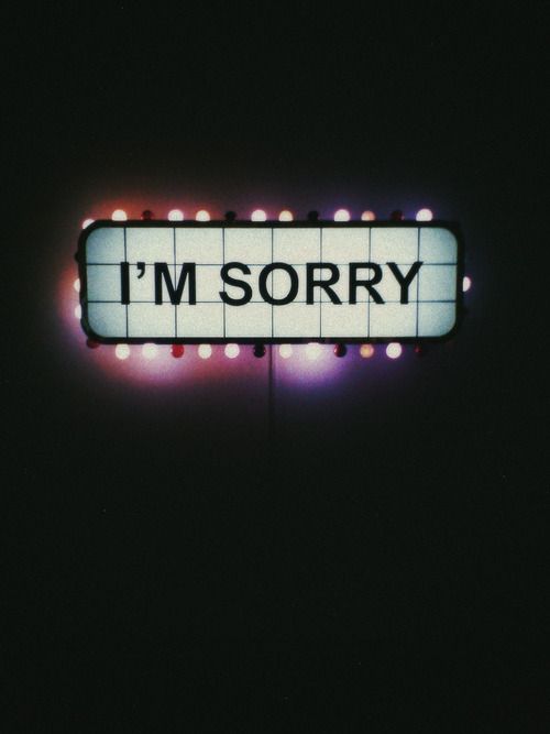 i'm sorry sign lit up in the dark