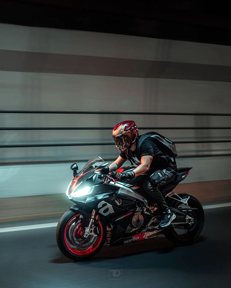 a man riding on the back of a black motorcycle