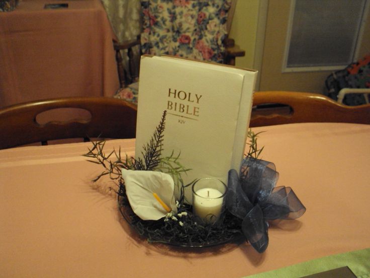 a table topped with a book and candles