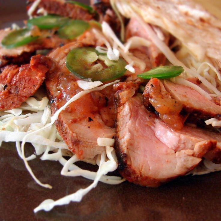 a close up of food on a plate with noodles and meat in the middle,