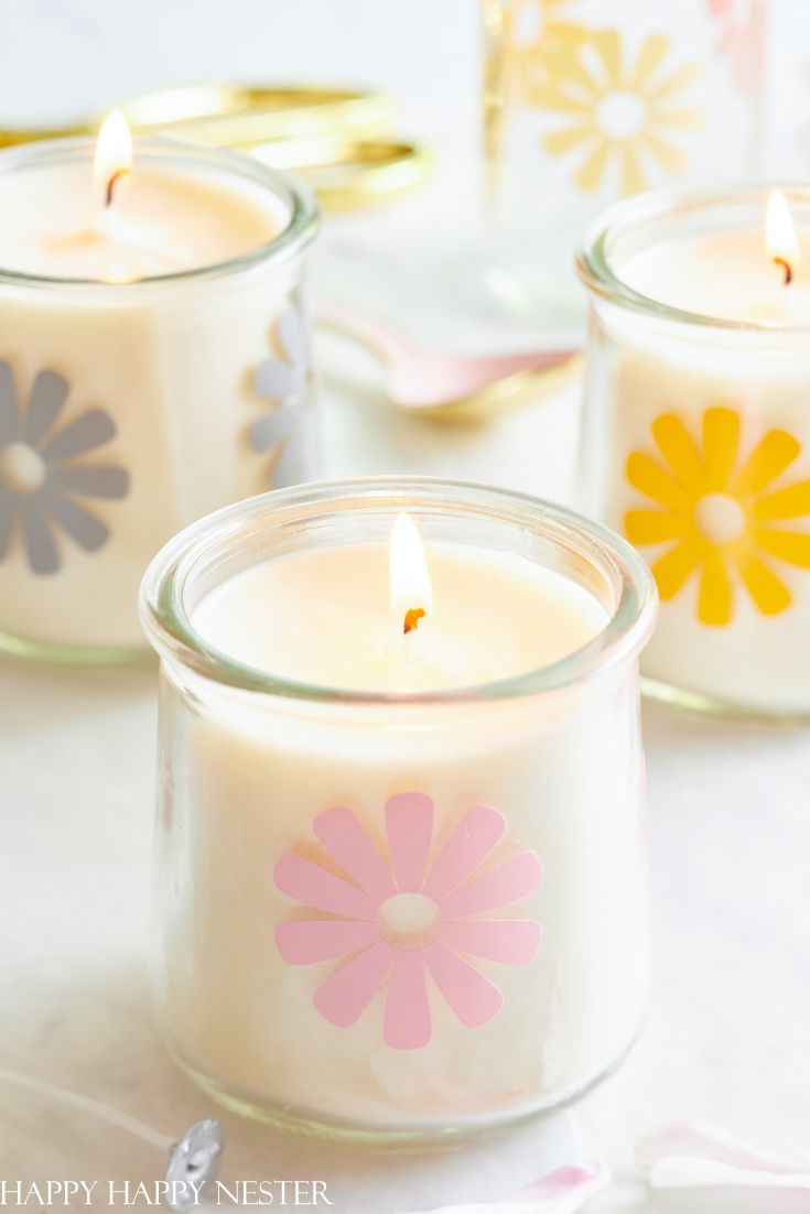 three candles with the words diy yogurt jar crafts on top and below