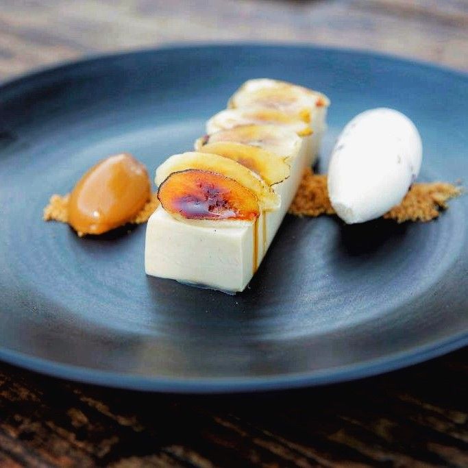 a blue plate topped with food on top of a wooden table