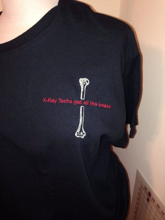 a woman wearing a black t - shirt with the words xray tooths get all the bones on it