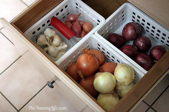 three baskets filled with onions on top of a tiled floor