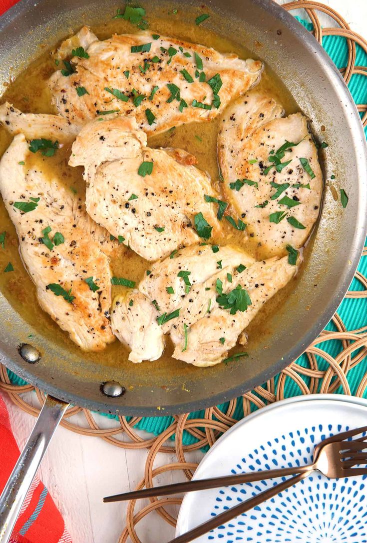 chicken in a pan with herbs on top