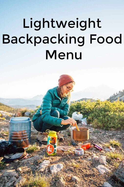 a woman sitting on top of a mountain next to food and drink bottles with the words light weight backpacking food menu