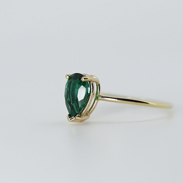 This beautiful Emerald Gold Ring was handmade in Melt'm Jewelry Design Studio in California using 14k solid yellow gold band and 9x7mm pear cut lab grown emerald stone. Emerald is featuring in 14k gold prong setting. DETAILS ABOUT THE RING, MATERIAL AND STONES Ring Band: 14K solid gold Ring Band size: 1.2 mm thick Gemstone: Lab grown Emerald Emerald size: 9mm x 7mm pear cut It is a great birthday gift for your special ones whose birthday are in May, since Emerald is May birthstone. This solid go Teardrop Emerald Ring With Prong Setting, Pear-shaped Emerald Ring For Promise, Classic Teardrop Emerald Ring As Gift, Pear-shaped Emerald Ring With Prong Setting As Gift, Classic Pear-shaped Green Emerald Ring, Solitaire Pear-shaped Emerald Ring For Gift, 14k Yellow Gold Pear-shaped Emerald Ring, Pear-shaped Emerald Ring For May Birthstone With Prong Setting, Pear-shaped Emerald Ring With Prong Setting For May Birthstone