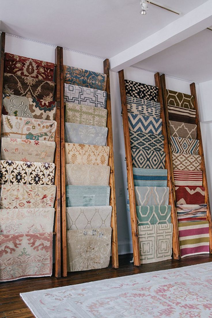 a room filled with lots of different rugs on the floor next to each other