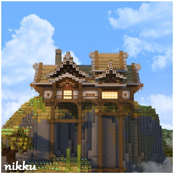 an image of a building made out of rocks and wood with the sky in the background