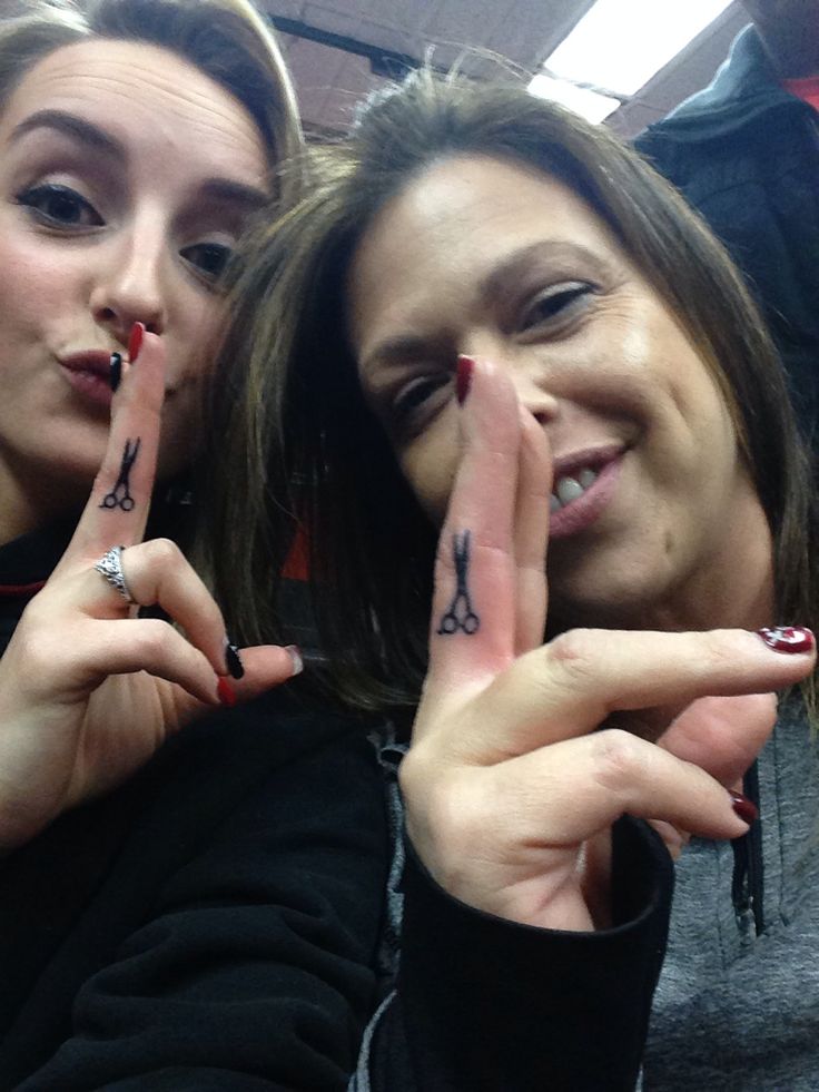 two women with their fingers in the shape of letters