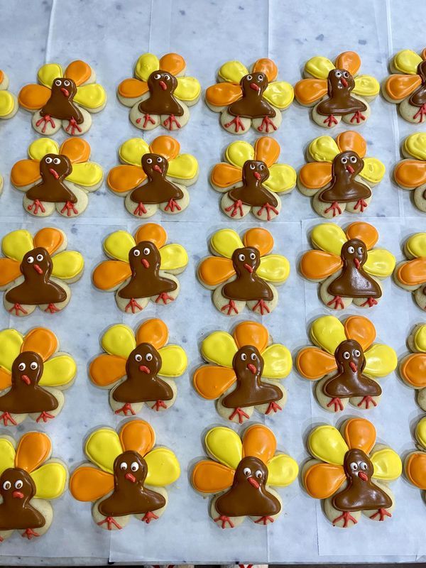 decorated cookies in the shape of turkeys on a table