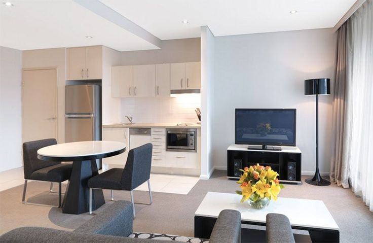 a living room filled with furniture and a flat screen tv on top of a wall