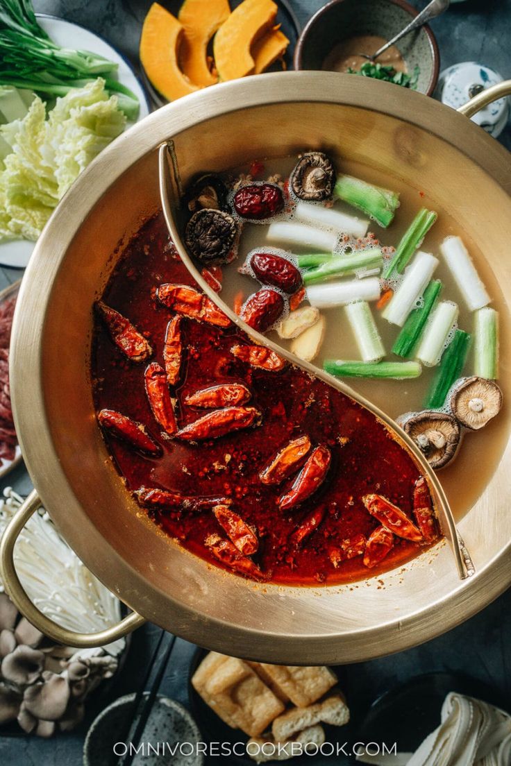 a large pot filled with lots of food on top of a table