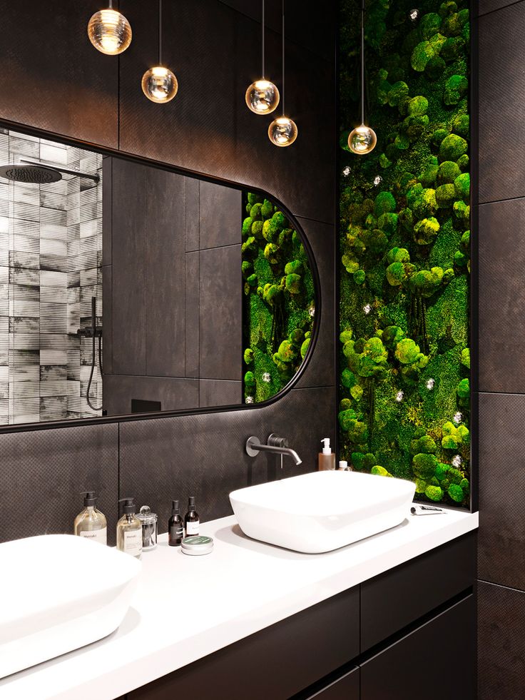 a bathroom with two sinks and a green wall in the backround behind it