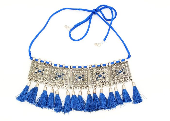 A cool and chic choker in silver with blue tassels, this festive necklace is a classy and elegant bohemian choice that goes with a variety of outfits.  Easy to wear when you want to complement an outfit with this blue and are ready to dazzle. #tlb #bohogift #Indian #Handmade #TribalBlueChoker Blue Bohemian Necklaces For Party, Bohemian Summer Party Choker, Festival Fringe Choker Necklace, Fringe Choker Necklace For Festival, Party Necklaces With Tassels, Bohemian Metal Tassel Necklace For Party, Elegant Blue Choker For Festivals, Fringe Tassel Necklace For Party, Festival Tassel Fringe Necklace