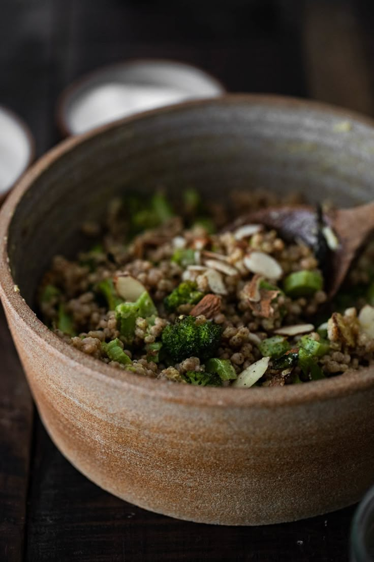 a wooden bowl filled with food on top of a table