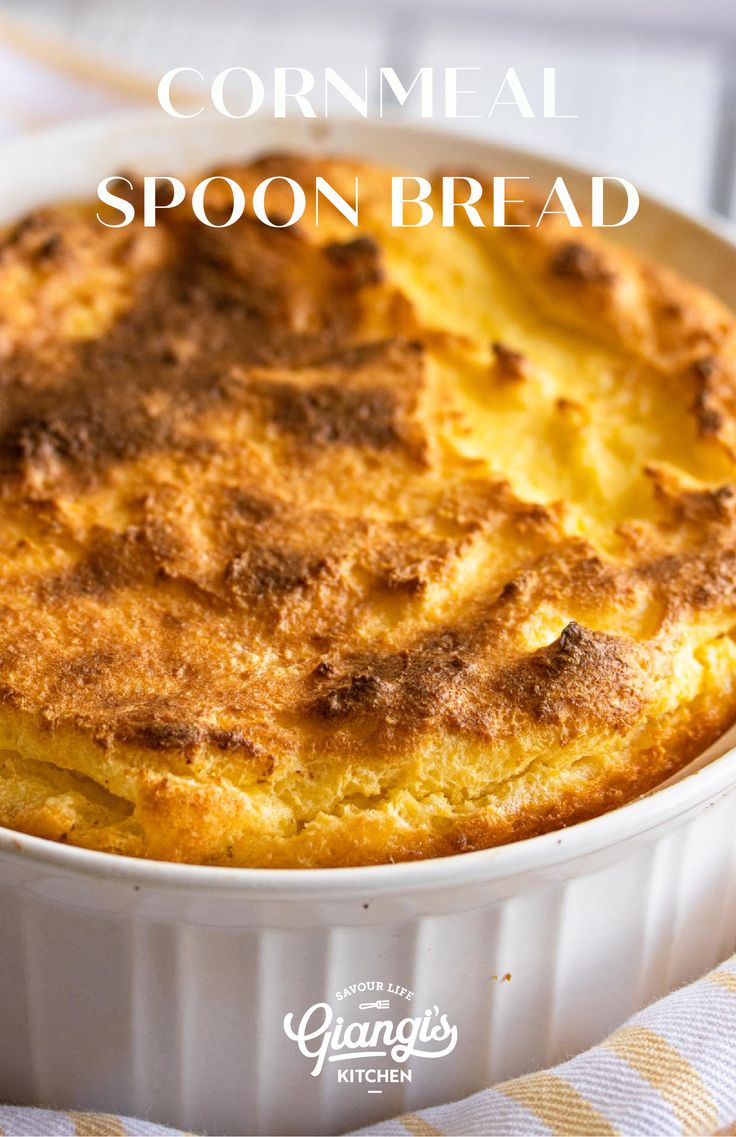 a close up of a casserole in a dish on a table with the words cornmeal spoon bread