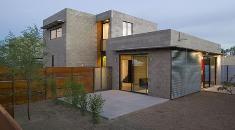 a modern house is shown in the evening