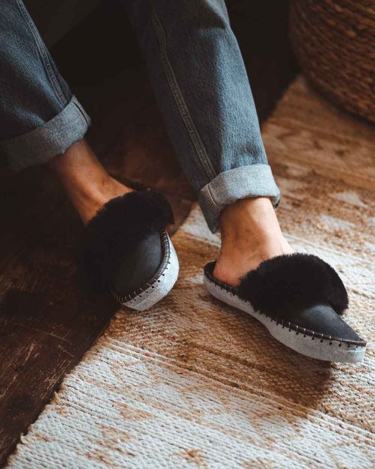 Inspired by our core range, our men's black mule range offering a modern classic on a traditional mule slipper, handmade from luxurious 100% sheepskin. Easy to slip on when you get home after a long day, our super comfortable mules include a 100% woolen lining and gloriously fluffy sheepskin cuff. Sheepers slippers are made by hand, some variations can occur and they are only to be worn indoors. Sheepskin and leather is a natural material so they will naturally flatten more information can be fo Black Leather Winter Slippers, Winter Leather Slippers With Textured Sole, Black Rubber Sole Slippers For Indoor Use, Black Indoor Slippers With Rubber Sole, Indoor Black Slippers With Rubber Sole, Black Leather Indoor Slippers, Comfortable Black Leather Slippers, Comfortable Black Slippers With Leather Sole, Black Leather Footbed Slip-on Slippers