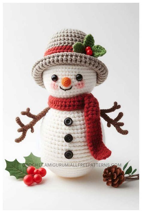 a crocheted snowman with a hat and scarf on it's head