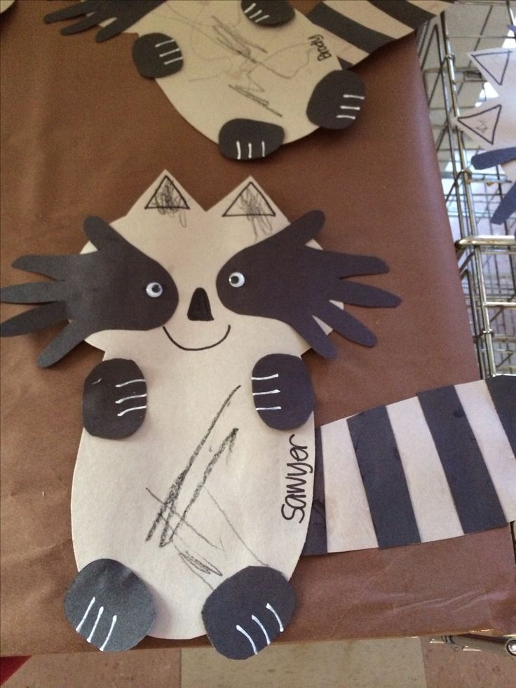 paper cut out of raccoon on top of a table