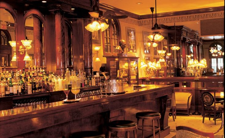 an old fashioned bar with lots of liquor bottles