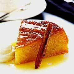 a piece of cake sitting on top of a white plate next to a cup and saucer